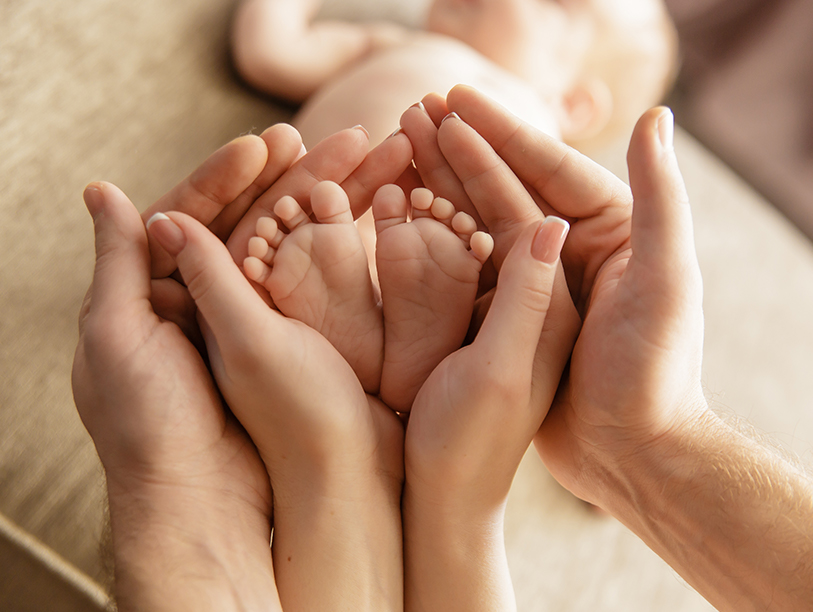 Baby feet and parent's hands